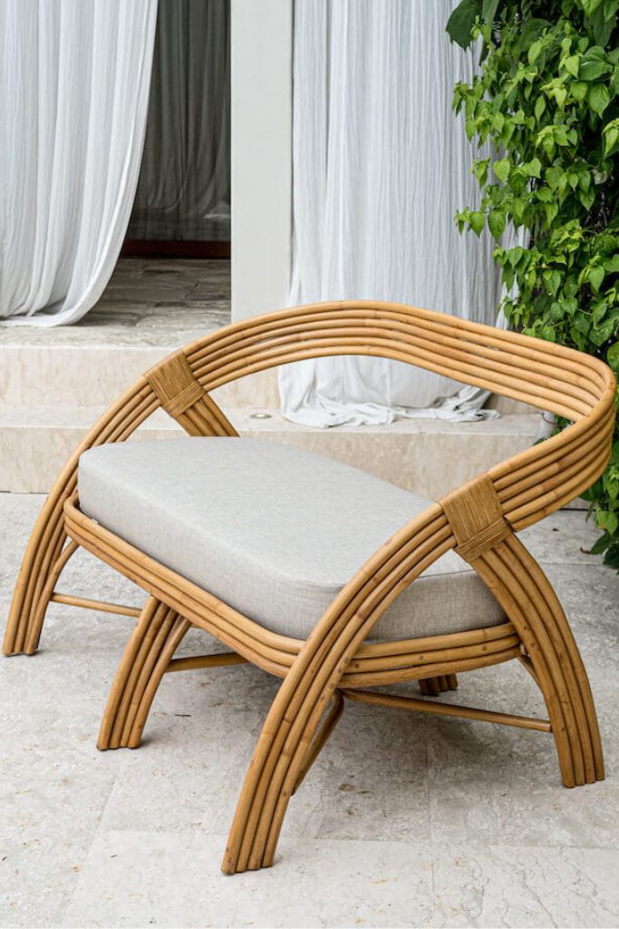 Handcrafted SALI sofa made from natural rattan with elegant flowing design and neutral tones, showcasing artisanal craftsmanship and timeless style