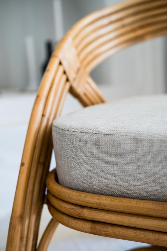 Handmade Sali rattan chair with opalescent autumn tones, cubic design, and soft seat cushion, perfect for natural and boho-inspired interiors.