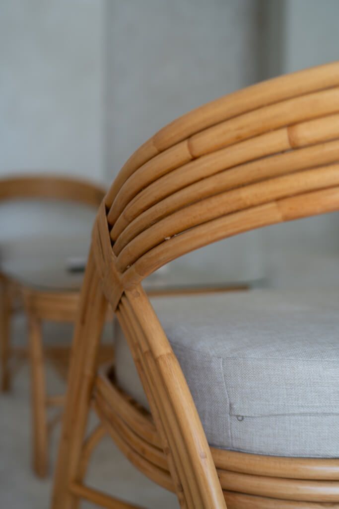 Handmade Sali rattan chair with opalescent autumn tones, cubic design, and soft seat cushion, perfect for natural and boho-inspired interiors.