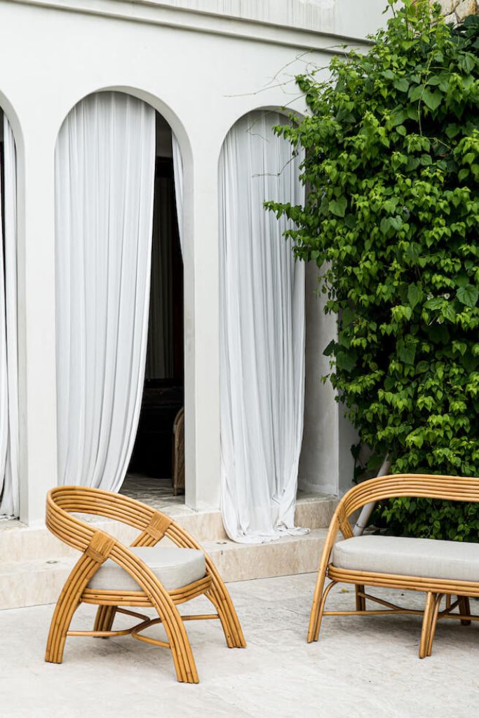 Handmade Sali rattan chair with opalescent autumn tones, cubic design, and soft seat cushion, perfect for natural and boho-inspired interiors.