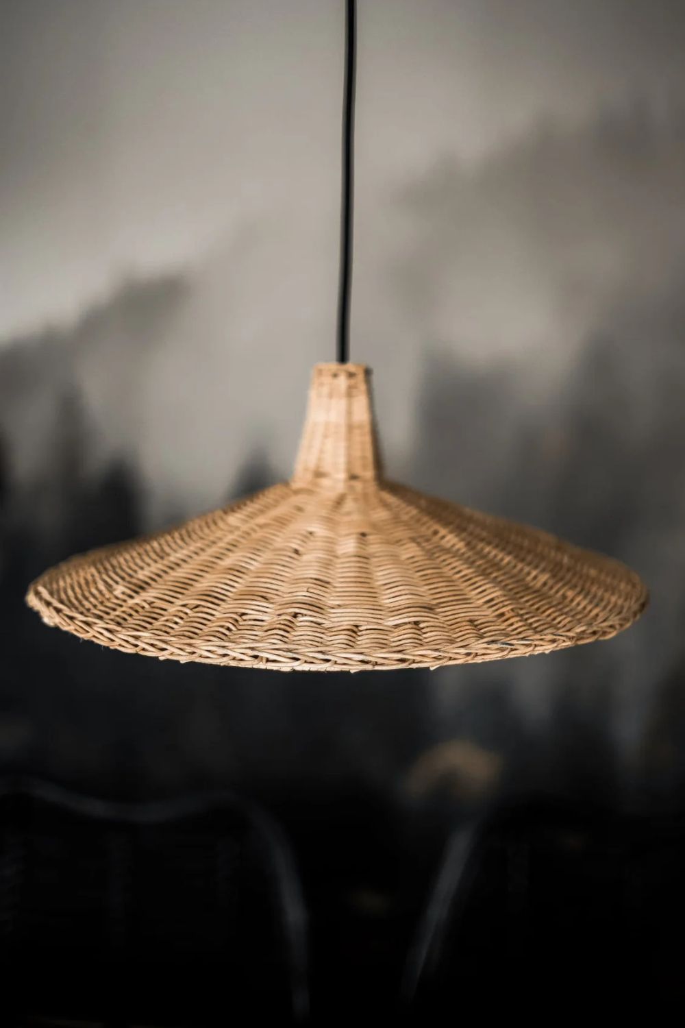 Handmade Sutter lamp in natural rattan with bohemian tropical design, perfect for stylish home décor