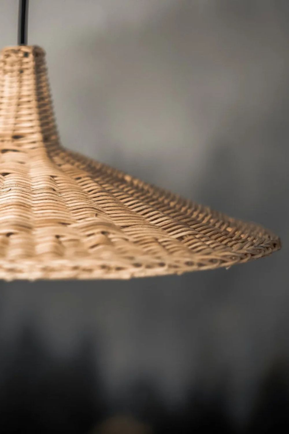 Handmade Sutter lamp in natural rattan with bohemian tropical design, perfect for stylish home décor