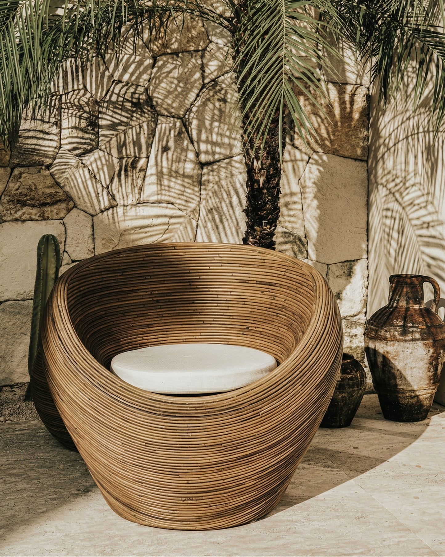 Handmade rattan armchair in dark brown with boho style, perfect for cozy living spaces