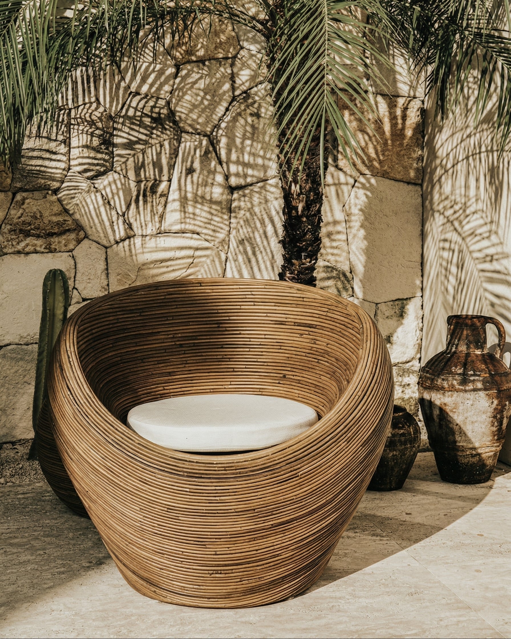 Handmade rattan armchair in dark brown with boho style, perfect for cozy living spaces