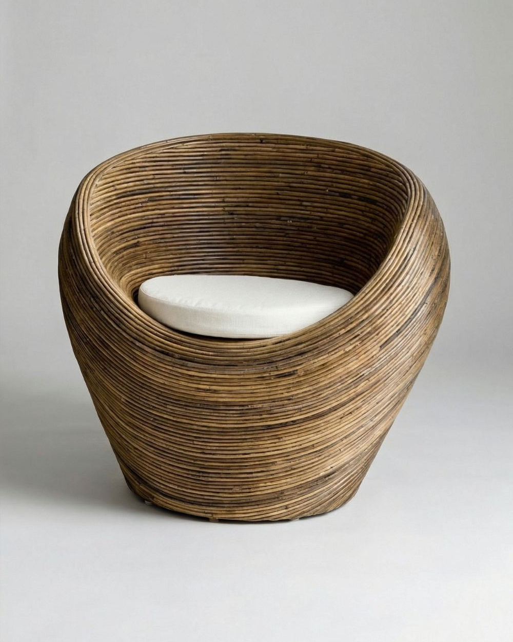Handmade rattan armchair in dark brown with boho style, perfect for cozy living spaces