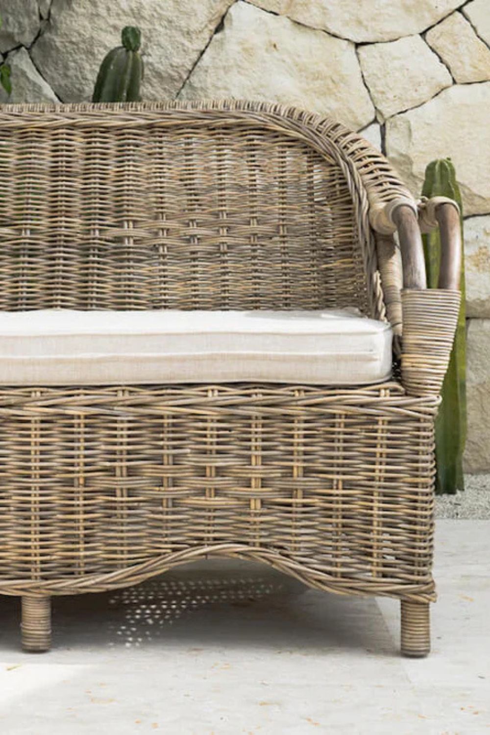 Tyo two-seater light brown rattan sofa with curved armrests