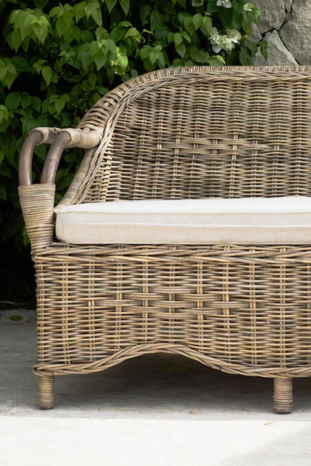 Tyo two-seater light brown rattan sofa with curved armrests